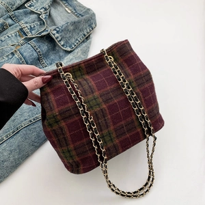 Fashionable purple plaid shoulder bag with stylish chain strap for women shown on denim