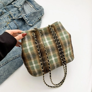 Green and brown plaid wool tote bag with chain strap and denim jacket accent