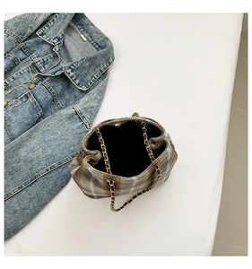 Top view of plaid drawstring bucket bag with metal chain handle and magnetic closure