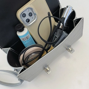 Silver crocodile texture crossbody bag showing internal space with phone and makeup