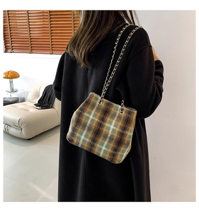Vintage wool plaid bucket bag with gold chain strap shown in a cozy interior setting
