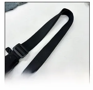Detail of adjustable black nylon shoulder strap with matte buckle for crescent bag