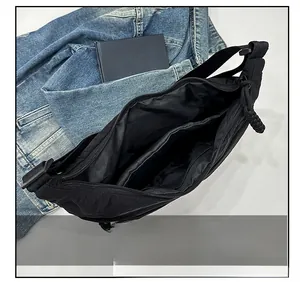 Top view of black crescent bag interior featuring zipper closure and internal pocket