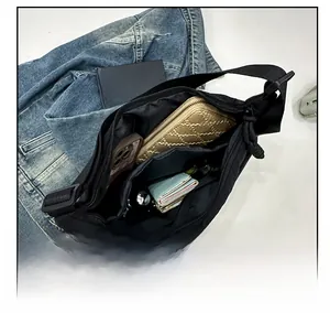 Internal view of black nylon crescent bag showing spacious compartment with zipper pocket