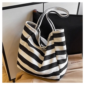 Detail shot of the textured herringbone canvas and black stripes on the large tote bag