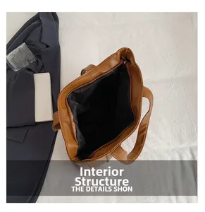 Internal structure of brown leather tote bag showing large capacity and black fabric lining
