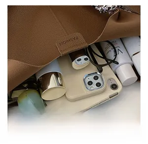 Internal view of a brown pebbled leather tote bag showing large capacity and fashion label
