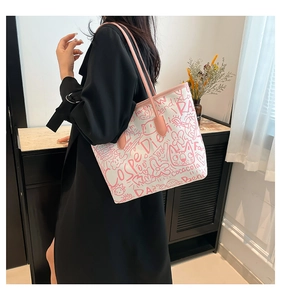 Detailed view of large white graffiti tote bag with pink straps and street art patterns