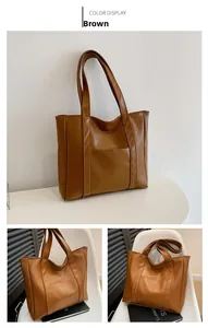 Detailed view of the brown leather tote bag showing exterior pocket and reinforced stitching
