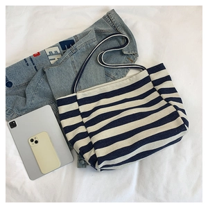 Detail view of large canvas tote bag with classic navy blue and white stripes