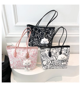 Detail view of American graffiti print tote bags with plush cloud charms and leather handles
