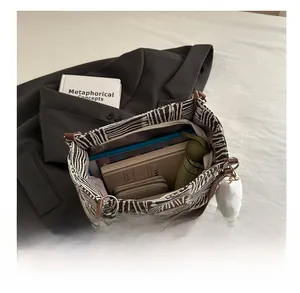 Top view of large canvas tote bag showing spacious interior with tablet and books