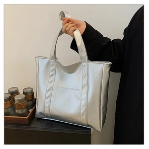 Detail of silver metallic tote bag with crinkled texture and large capacity design