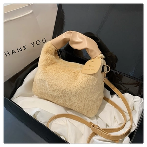Detail of beige plush handbag with soft faux fur texture and elegant silk lining