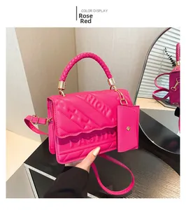 Detail of rose red bag featuring fashion letter embossing and braided handle texture