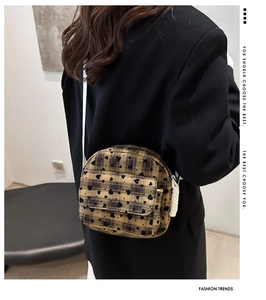 Detail of checkered crossbody bag with black hearts and white rope strap on a model
