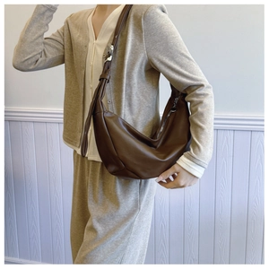 Detail view of smooth dark brown leather hobo bag with adjustable silver buckle strap