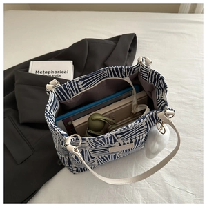 Detail view of large canvas tote bag interior showing spacious storage for tablet and books