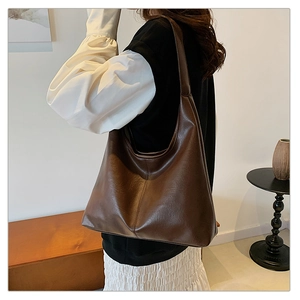 Detail view of a large dark brown hobo shoulder bag in soft synthetic leather for women