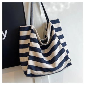 Close-up of navy blue and white striped canvas tote bag with thick twill texture