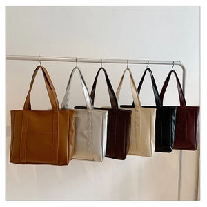 Minimalist large tote bags shown in six colors including brown, silver, and black