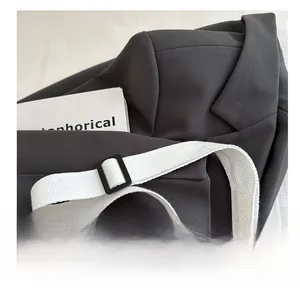 Detail of adjustable wide woven shoulder strap and black buckle on contrast shell bag