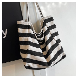 Close-up of black and white striped canvas tote bag with durable double straps