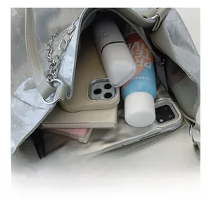 Detailed view of the silver tote bag interior showing large capacity and organizational space