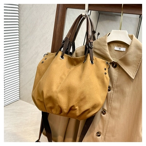 Detailed view of ginger canvas tote bag with drawstring texture and brown strap