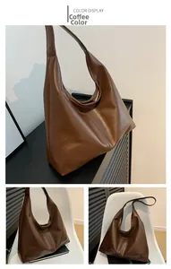 Detail view of large dark brown retro tote bag showing smooth faux leather texture