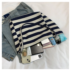 Detail shot of large striped canvas tote bag showing interior storage capacity and items