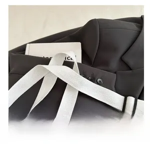 Detail of adjustable wide canvas shoulder strap with buckle for leopard print crossbody bag