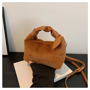 Detail of brown faux fur handbag with ruched leather handle and thin crossbody strap