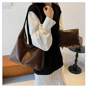 Vintage dark brown large tote bag with matching pouch shown in minimalist modern setting