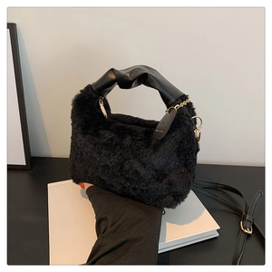Detailed macro view of soft black faux fur texture and knotted leather handle of the handbag