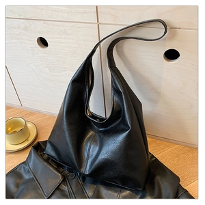Minimalist black large capacity hobo bag detail in high quality PU leather texture