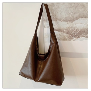 Macro detail of high-quality brown faux leather texture on minimalist large tote bag