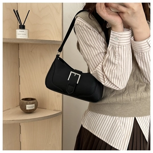 Chic black leather crescent underarm bag with silver square buckle shown on model