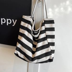 Large striped canvas tote bag for women featuring classic black and white herringbone weave