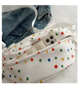 Detailed internal storage of white canvas bag with colorful polka dots and silver zipper