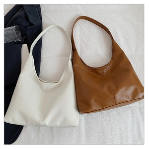 Detailed view of white and brown retro Hobo tote bags showing soft leather texture