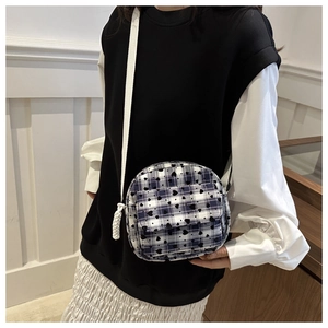 Detail of plaid mini crossbody bag with heart prints and decorative braided ropes