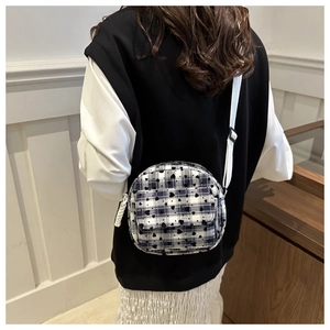 Detail of round mini crossbody bag with black hearts and checkered canvas pattern