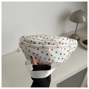 Detailed close-up of a white canvas chest bag featuring colorful rainbow polka dot patterns