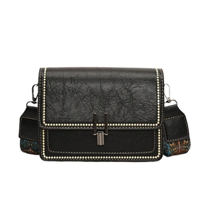 Retro black crossbody bag with contrast stitching and ethnic patterned wide strap