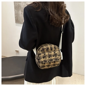 Detailed back view of a plaid heart-pattern crossbody bag with white woven shoulder strap