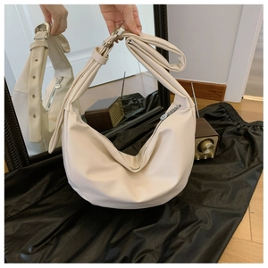 Minimalist cream semi-moon crossbody bag with wide strap and silver metal hardware