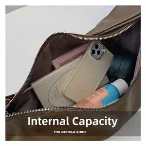 Brown soft leather dumpling bag interior showing large capacity for essentials