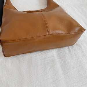 Minimalist caramel brown faux leather tote bag with large capacity and pebbled texture