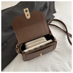 Interior view showing the large storage capacity of this vintage brown crossbody bag